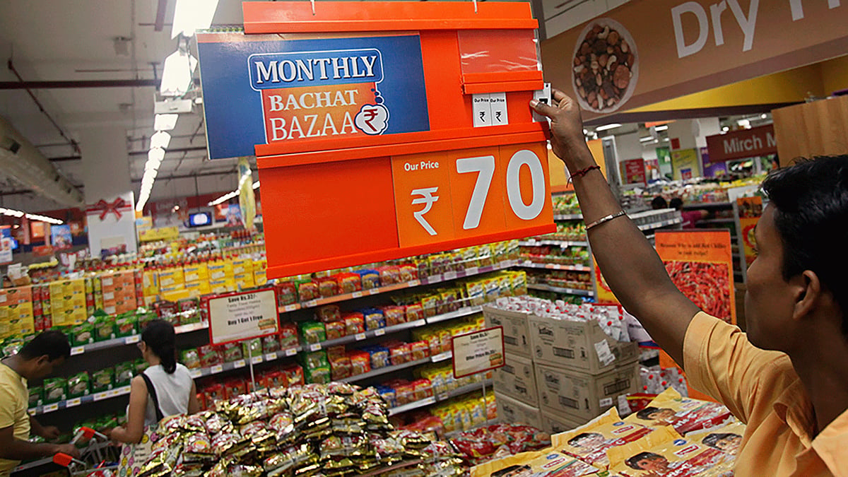An employee changes the price tag of a product at the Big Bazaar retail store.