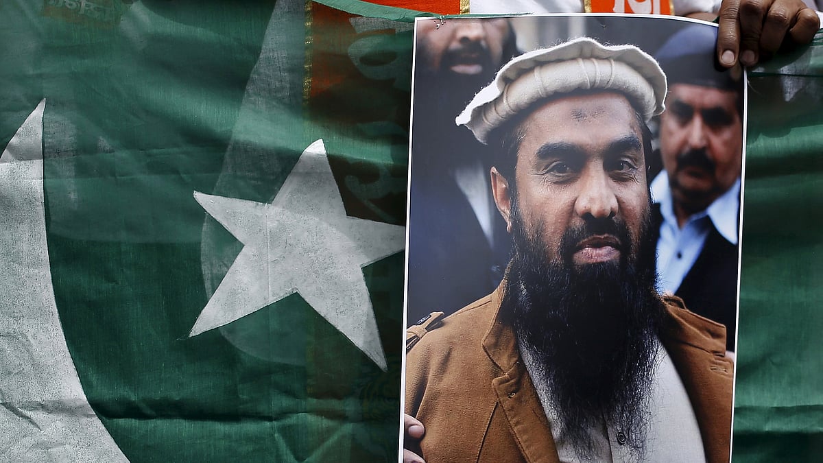 File photo of a Pakistani flag with Lakhvi’s photograph on it. (Photo: Reuters)