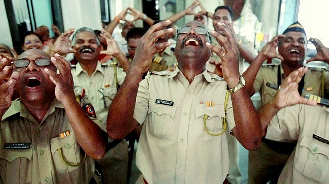 Mumbai Police personnel participate in a laughter therapy session at a Police station in Mumbai on Monday. (Photo: PTI)