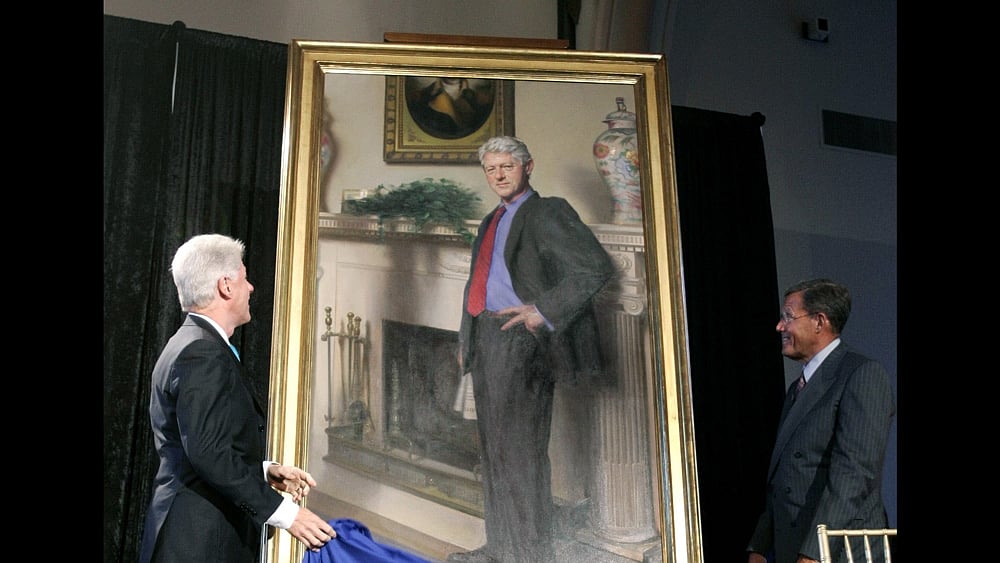 File photo of former President Bill Clinton looking up at his portrait, painted by artist Nelson Shanks. (Photo: AP)