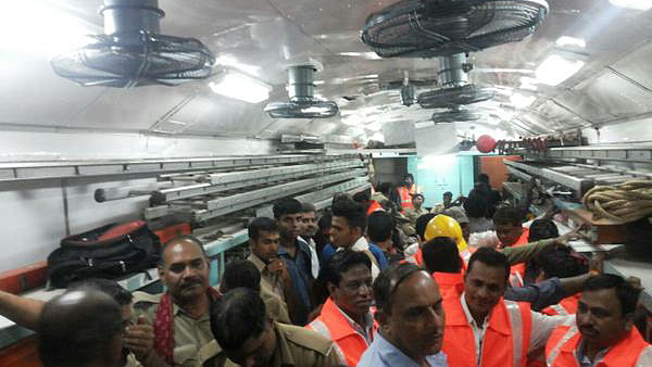 Disaster and rescue officials inside a train bogey which derailed near Harda town in Madhya Pradesh. (Photo: ANI)