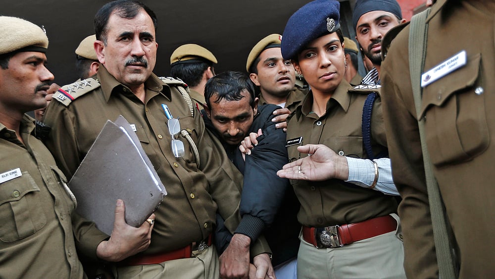 Policemen escort Uber taxi&nbsp;driver Shiv Kumar Yadav (Centre in black jacket) who is accused of a rape outside a court in New Delhi December 8, 2014.&nbsp;(Photo: Reuters)
