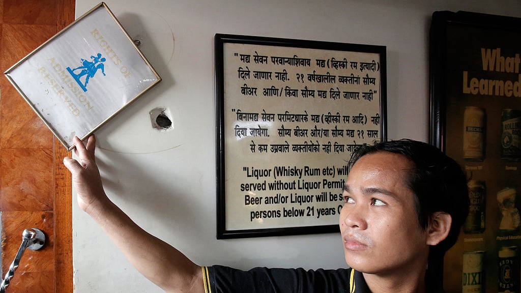 A staff member displays a bullet hole on the wall of Leopold Cafe, which was one of the targets of the&nbsp;26/11 terror attack in Mumbai, November 21, 2012. (Photo: Reuters)