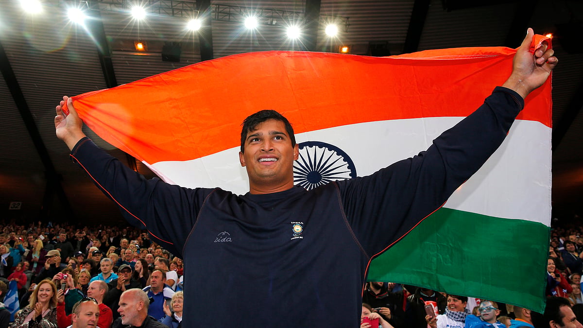 Vikas Shive Gowda celebrating with the country’s flag after winning the gold medal in the men’s discus final at the 2014 Commonwealth Games in Glasgow. (Photo: Reuters)