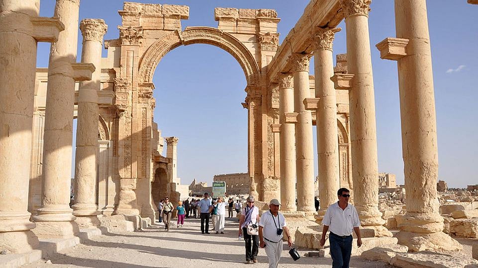 Tourists walk through the ancient city of Palmyra (Photo: Reuters)