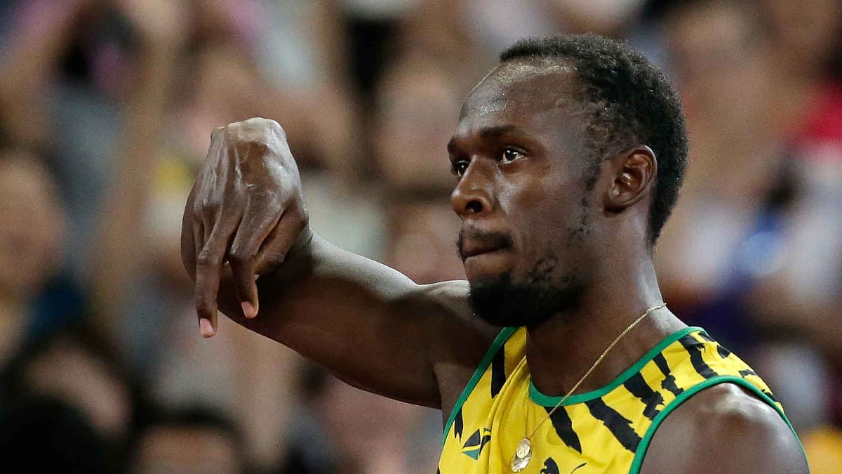 Usain Bolt reacts after his opening heat at the World Championships in Beijing. (Photo: AP)
