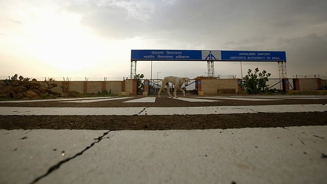 A dog walks past the main entrance of the Jaisalmer Airport. (Photo: Reuters)  