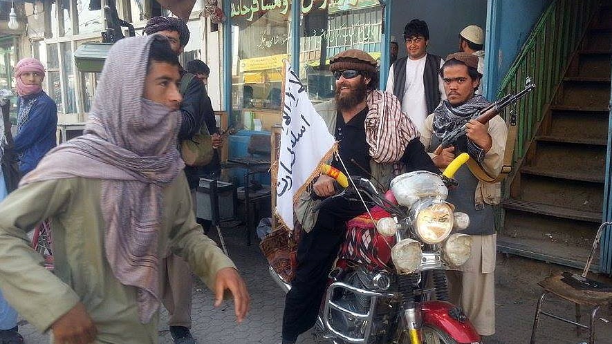A Taliban fighter sits on his motorcycle adorned with a Taliban flag in a street in Kunduz city, north of Kabul, Afghanistan, Tuesday, September 29, 2015. (Photo: AP)