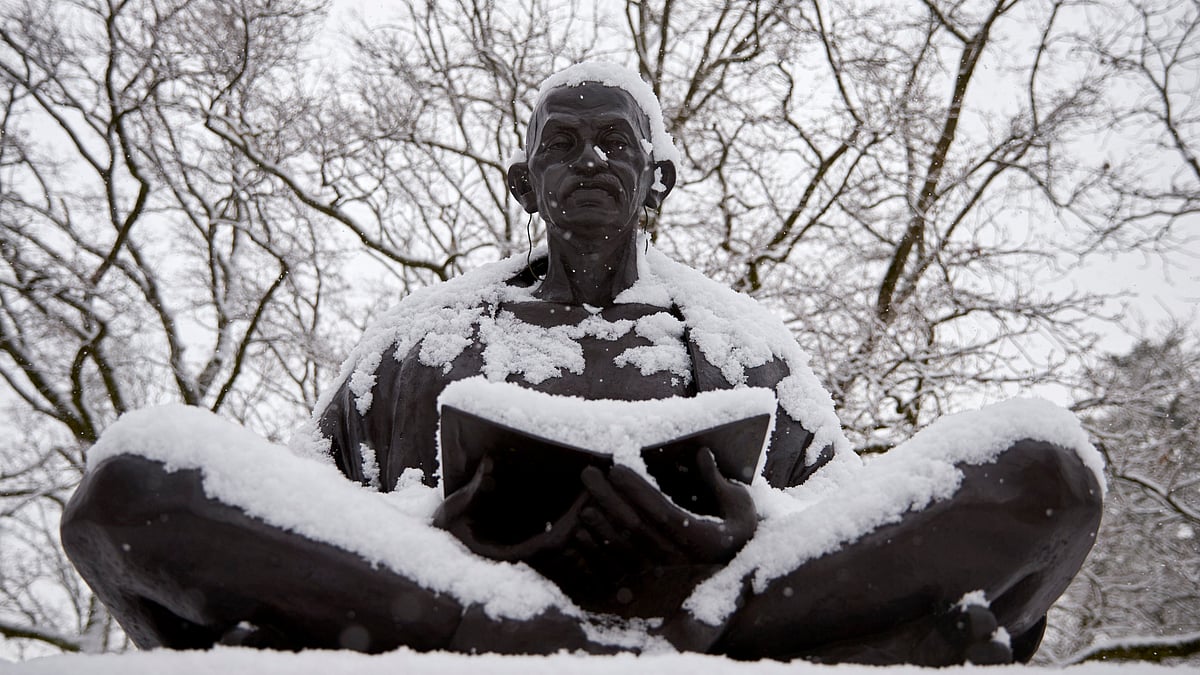 Snow falls on a statue of Mahatma Gandhi on a winter morning in Geneva. (Photo: Reuters)