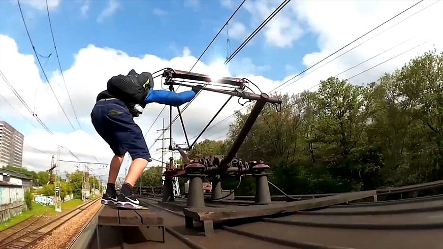 Teenagers are risking their lives in a deadly craze of clinging to the roofs of trains. (Photo: AP screengrab)