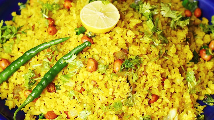 Drizzled with coriander and a hint of potato sev, these pohas make for a sumptuous Maharashtrian breakfast. (Photo: iStock)