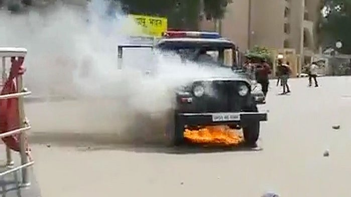 Police vehicle set ablaze by protesters in Lucknow. (Photo: ANI)