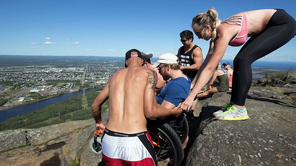Friends helping Jeff Carlson climb Thunder Bay’s highest peak in Ontario, Canada. (Photo: AP screengrab)