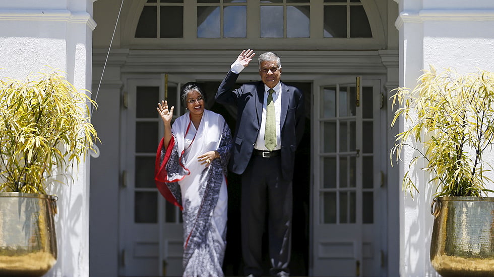 Ranil Wickremesinghe (R), leader of Sri Lanka’s United National Party (UNP), waves next to his wife Maitree Wickremesinghe at the PM’s official residence in Colombo. (Photo: Reuters)