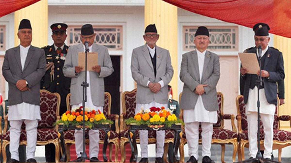Nepal’s President Ram Baran Yadav (second from left), administers the oath of office to newly elected Prime Minister Khadga Prasad Oli (extreme right) at the Presidential building in Kathmandu. (Photo: PTI)