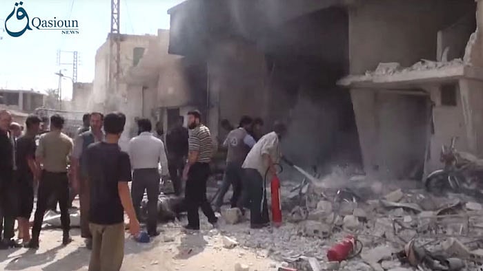 People in Dair al-Asafeer village, rural Damascus, Syria use a fire extinguisher after the air strike. (Photo: AP)
