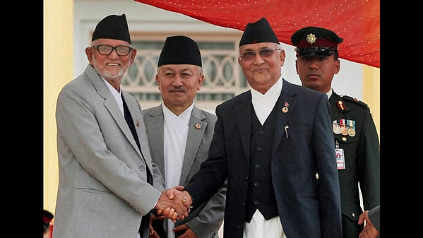 Nepal’s newly elected PM KP Sharma Oli and former PM Sushil Koirala shake hands. (Photo: PTI)