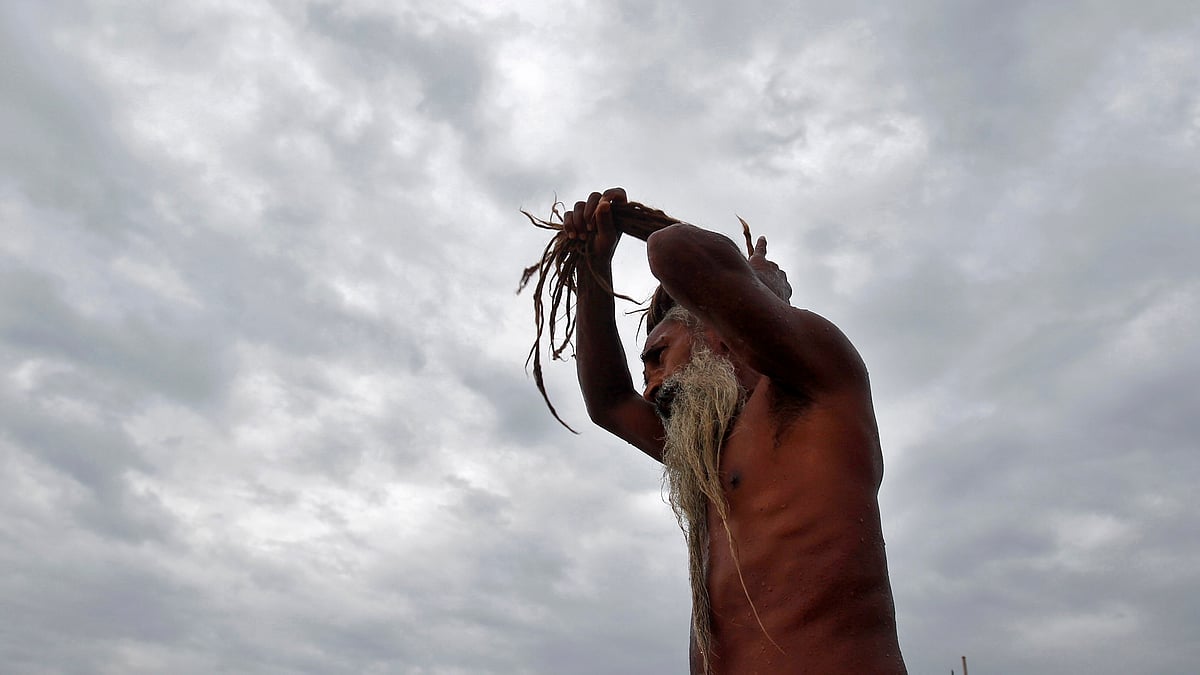 A sadhu adjusts his dreadlocks after taking a holy dip in the waters of Sangam in Allahabad. (Photo: Reuters)