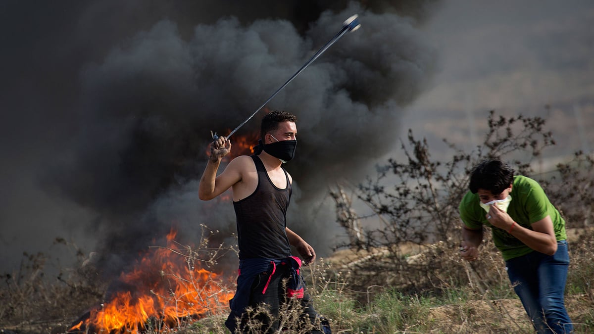 A Palestinian protester hurling stones at Israeli soldiers near the Israeli border with Gaza. 