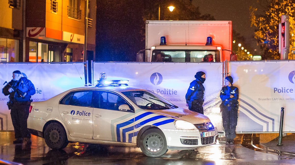 Belgian police guard a street in Brussels on Saturday where arrests were made linked to the attacks in Paris. (Photo: AP)
