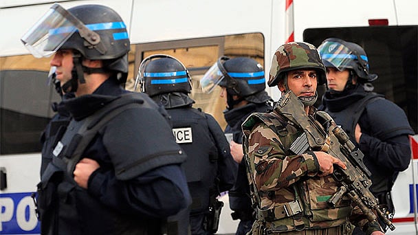 French soldiers and policemen patrol in Saint-Denis near an apartment that was under seige in the area where suspected jihadists were hiding. (Photo: AP)