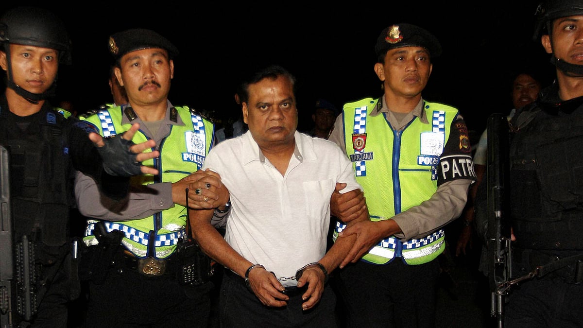 Chhota Rajan escorted by Bali police&nbsp;before being deported to India. (Photo: PTI)