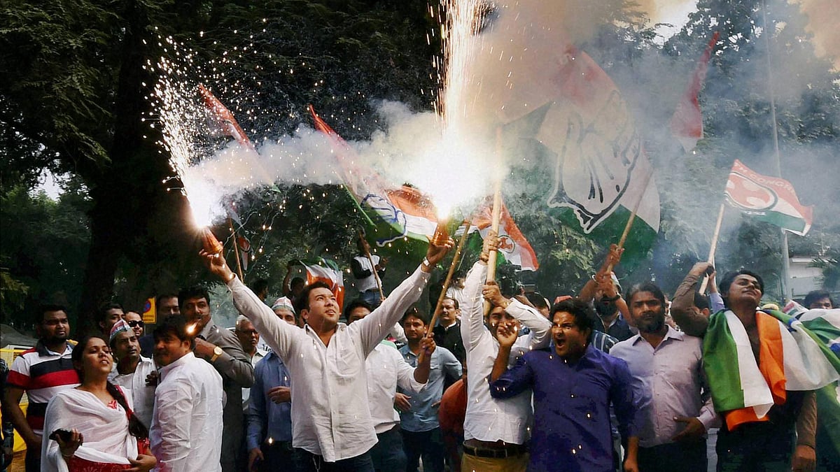 Congress supporters burn crackers as they celebrate Bihar poll results at party headquarters in New Delhi. (Photo: PTI)