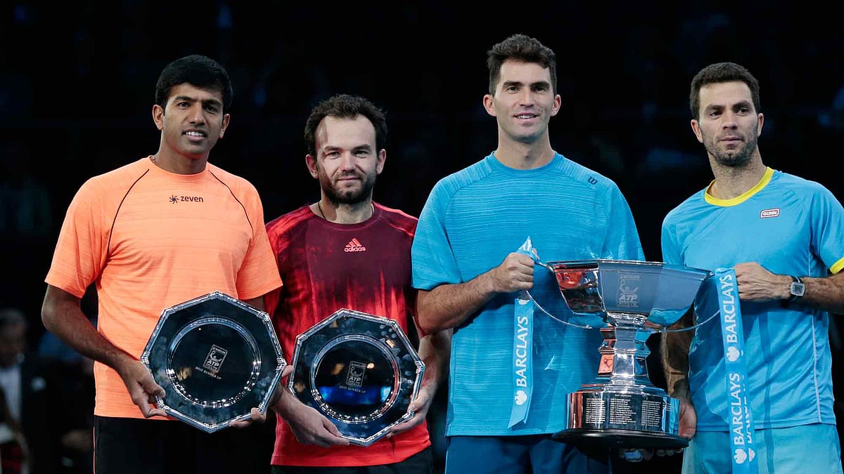 Netherlands’ Jean Julien Rojer and Romania’s Horia Tecau (both in blue) celebrate with runners up Rohan Bopanna of India and Florin Mergea of Romania after winning the final. (Photo: Reuters)