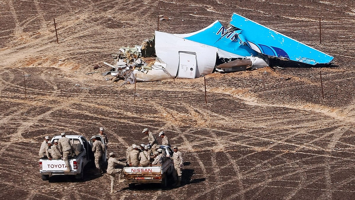 Egyptian military cars approach a plane’s tail at the wreckage of a passenger jet bound for St Petersburg in Russia that crashed in Hassana, Egypt. (Photo: AP)