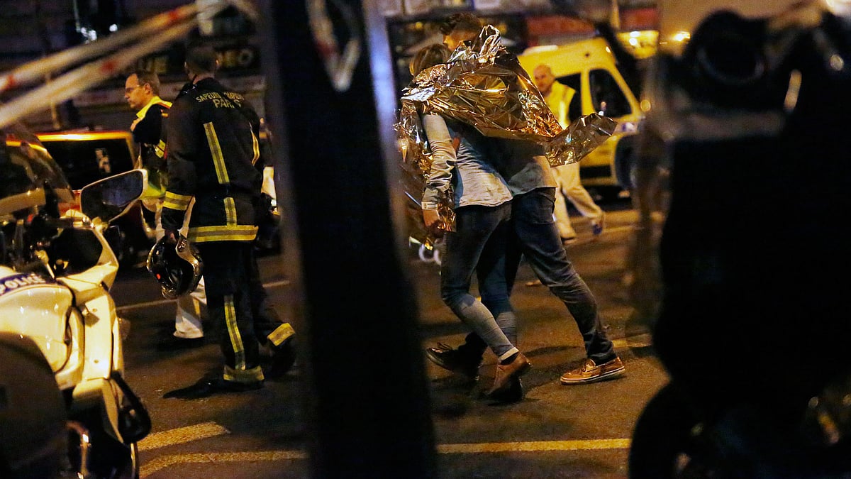 A person being evacuated after a shooting outside the Bataclan theatre in Paris. (Photo: AP)