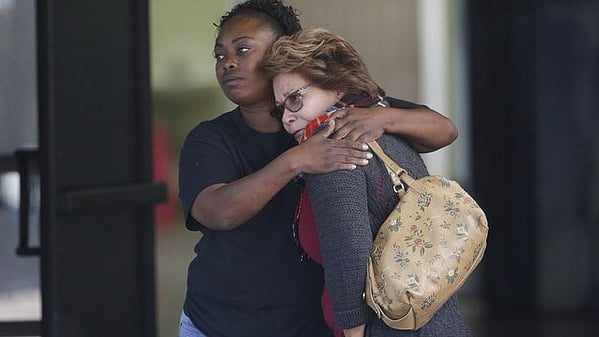 Two women embrace at a community centre where family members are gathering to pick up survivors after a shooting rampage that killed multiple people and wounded others at a social services centre in San Bernardino, California, Wednesday, December 2, 2015. (Photo: AP)