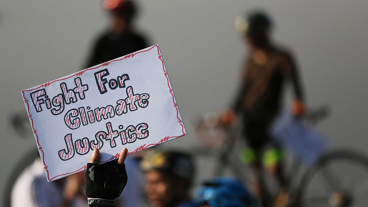 A Filipino activist raises a slogan during a rally in Manila, Philippines on December 13, 2015 to criticise the agreement reached during the United Nations conference on climate change, COP21 in Paris. (Photo: AP)