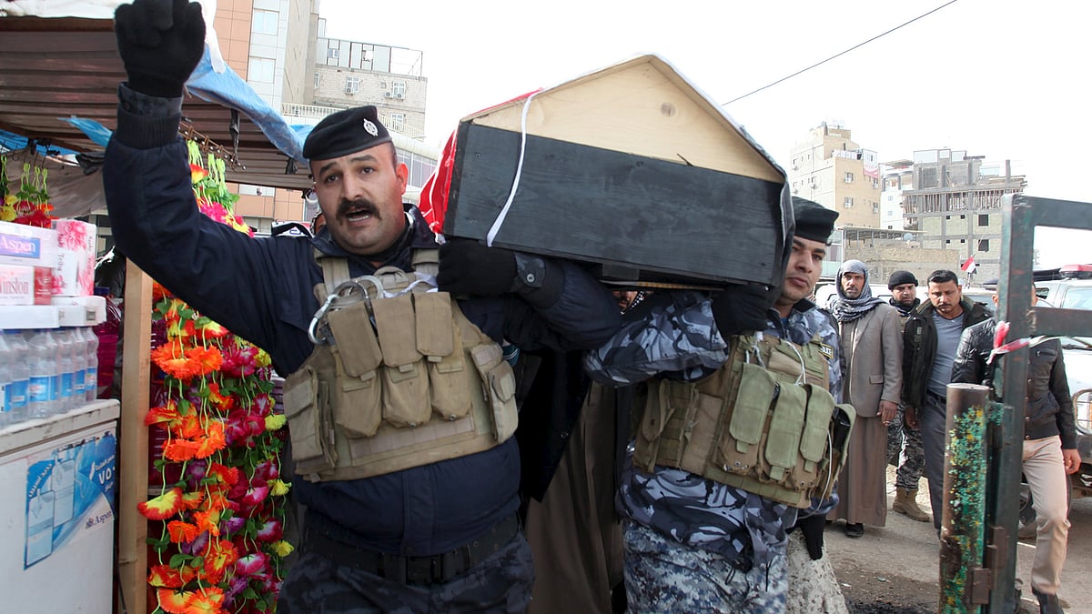 Mourners carry the coffin of a member from the Iraqi
security forces, who was killed in Ramadi. (Photo: Reuters) 