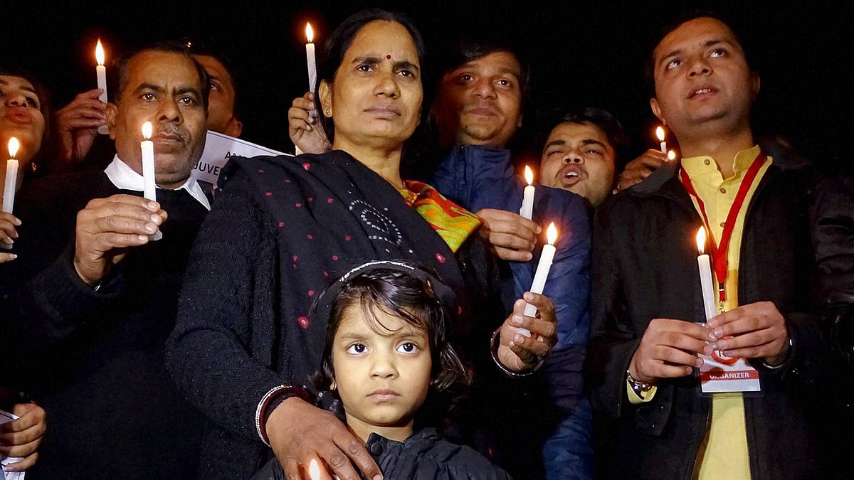 Father of Dec 16 gangrape victim, Badri Singh Pandey and mother Asha during a candle light protest at Jantar Mantar, in New Delhi on Monday. (Photo: PTI)