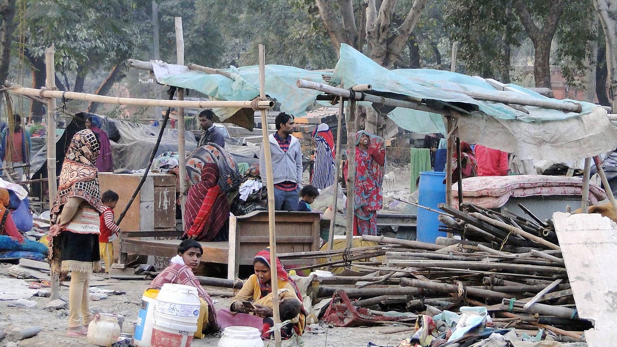 People collect their belongings after a demolition drive in Shakur Basti, Delhi. (Photo: PTI)