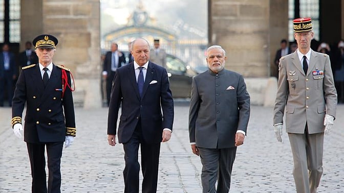 File photo of PM Narendra Modi, accompanied by French Foreign Minister Laurent Fabius. (Photo Courtesy: Twitter/@francediplo)