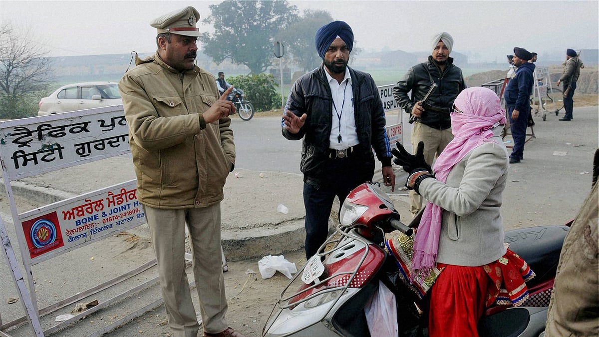 Policemen standing guard at Bhullaechak Colony village near Tibri Cantt in Gurdaspur village. (Photo: PTI)