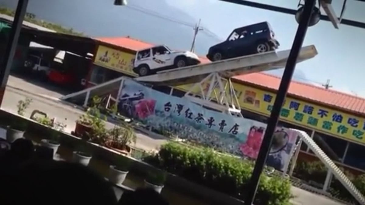 4x4 cars play on a giant seesaw for a performance at a tourist attraction in China. (Photo: AP screengrab)