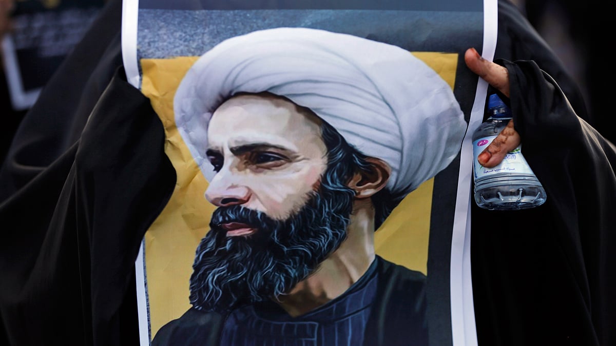 A Bahraini protester holds a picture of Saudi Shiite cleric Sheikh Nimr al-Nimr during a rally denouncing the execution of Shiite cleric Sheikh Nimr al-Nimr by Saudi Arabia, Sunday, 3 January 2016, in Daih, Bahrain. (Photo: AP)