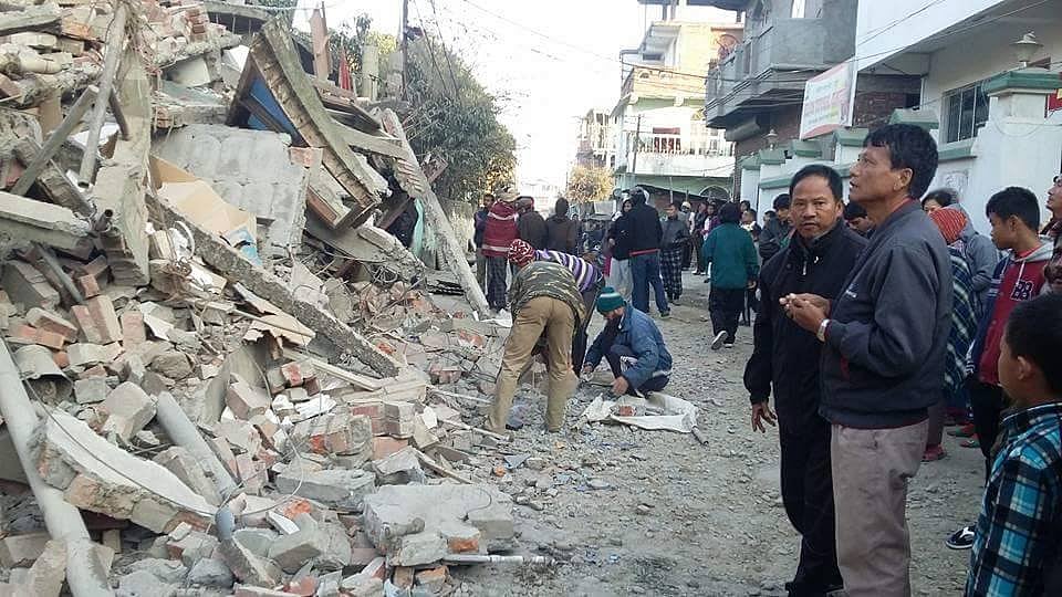 People look at the rubble as the after effects of the quake in Manipur (Photo courtesy:<i> Manipur Times</i>’ <a href="https://www.facebook.com/ManipurTimes/">Facebook Page</a>)