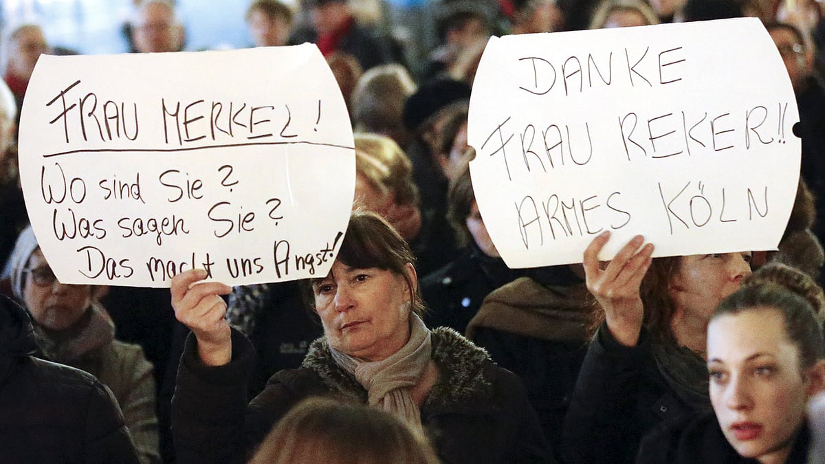 Women hold up placards that read “Mrs. Merkel: Where are you? What are you saying? This worries us!” during a protest in front of the Cologne Cathedral. (Photo: Reuters)