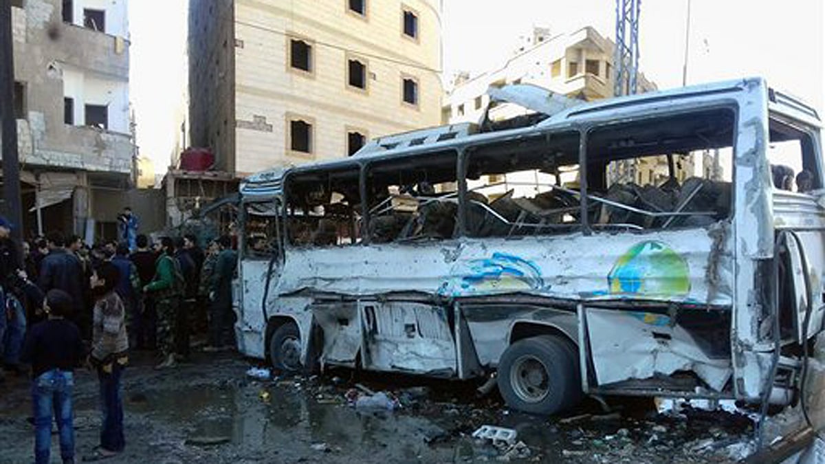 Syrians gather where three bombs exploded in Sayyda Zeinab, a predominantly Shiite Muslim suburb of the Syrian capital. (Photo: AP)