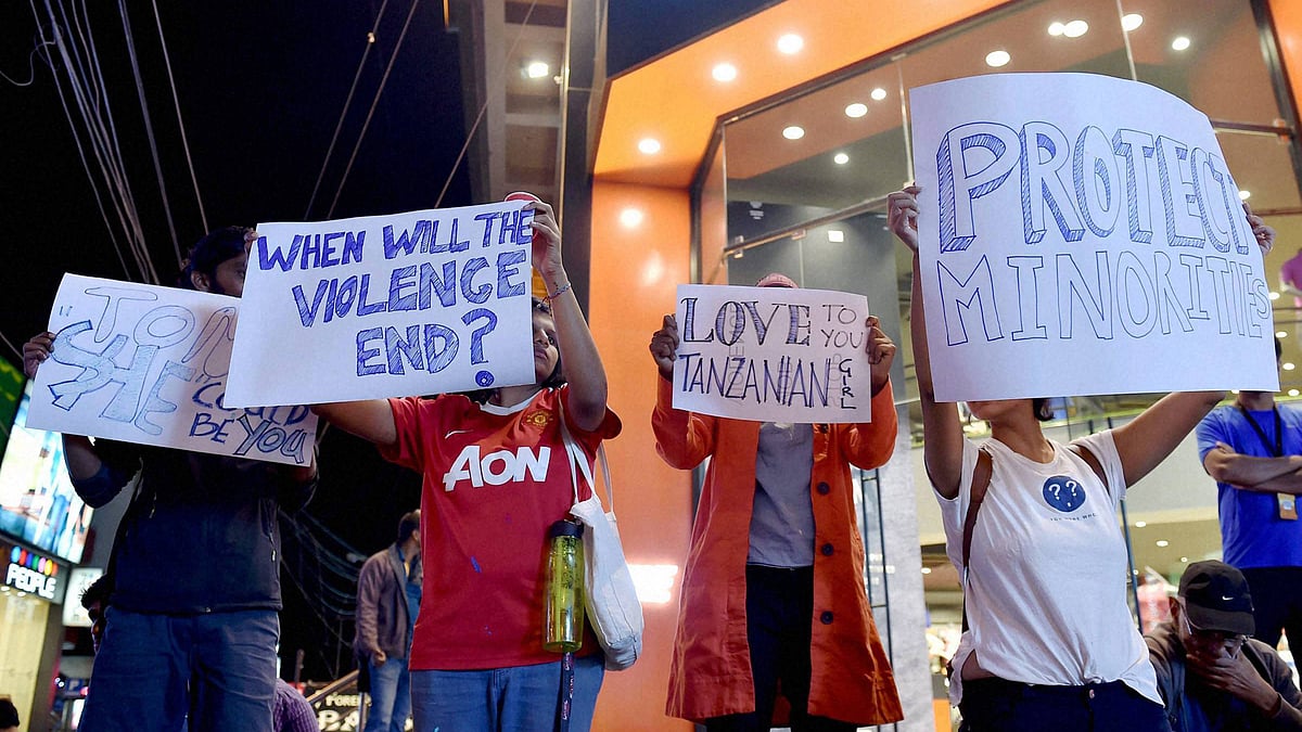  Students from different colleges hold placards and candles during a protest against the attack on a Tanzanian Girl by a mob in Bengaluru on Thursday. (Photo: PTI)