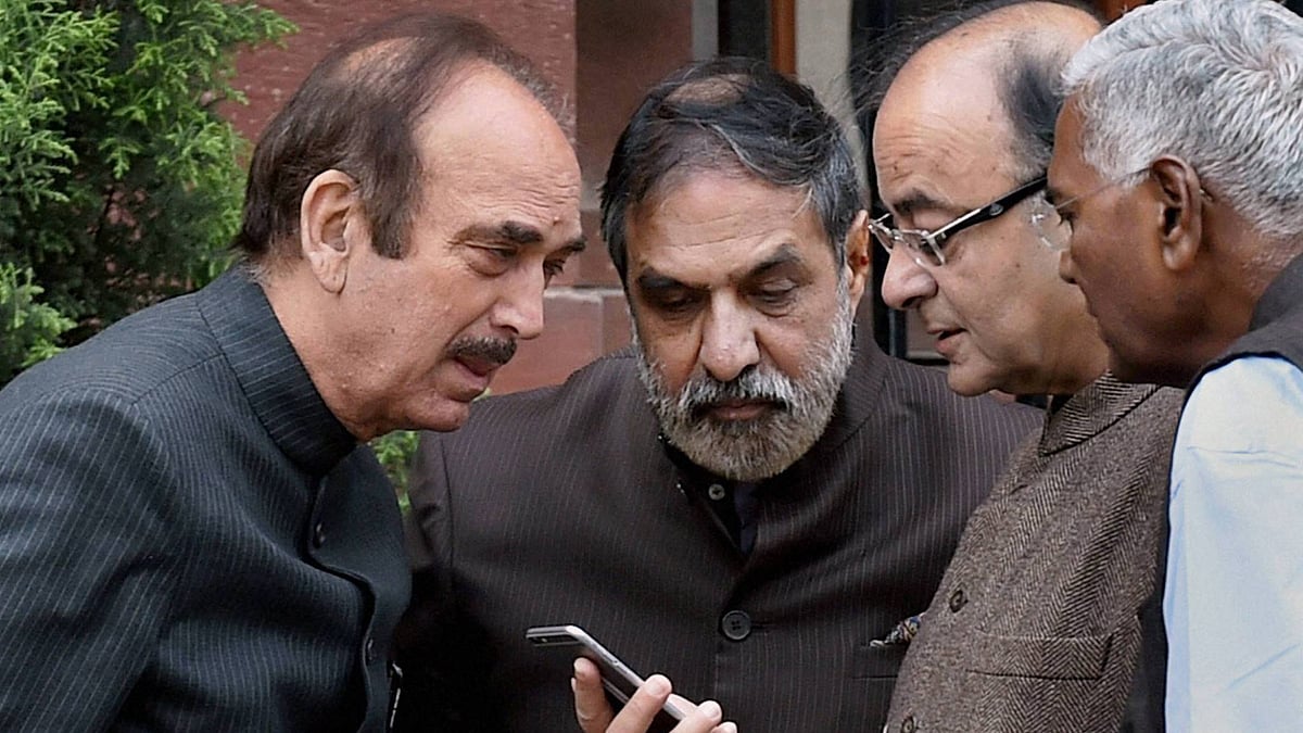 Ghulam Nabi Azad, Anand Sharma, Arun Jaitley and D Raja indulge in some mobile-time. (Photo Courtesy: PTI)