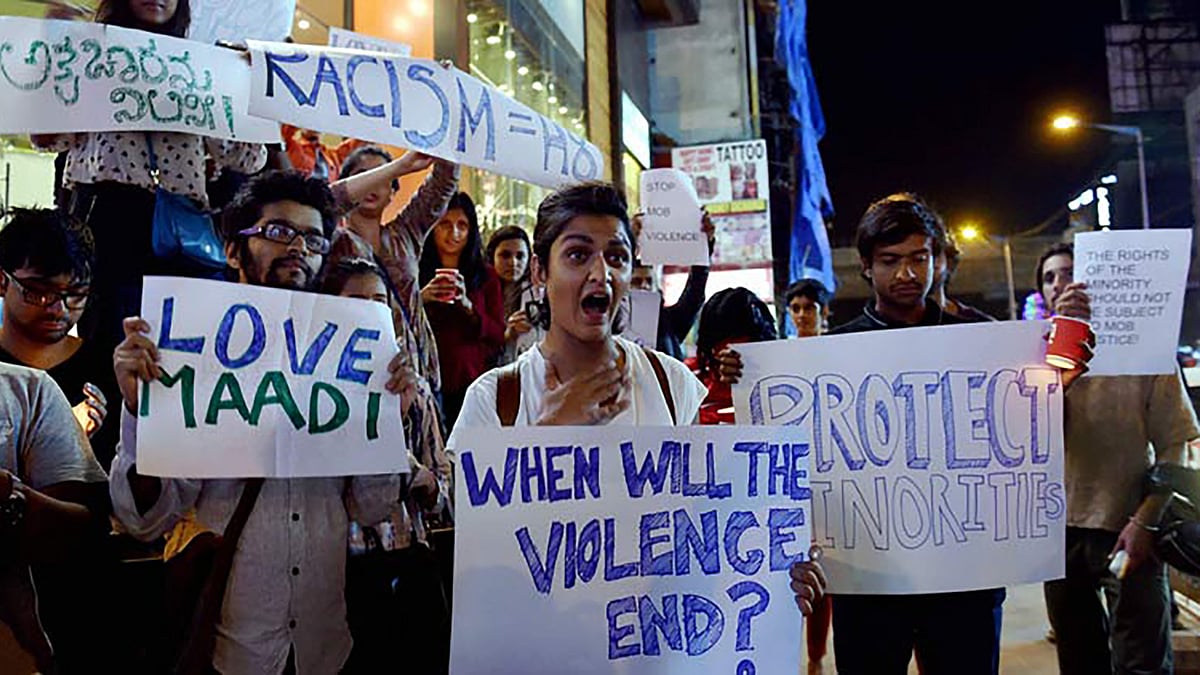 Students from different colleges hold placards and candles  during a protest against the attack on a Tanzanian Girl by a mob in Bengaluru
on Thursday. (Photo: PTI) &nbsp; &nbsp;  