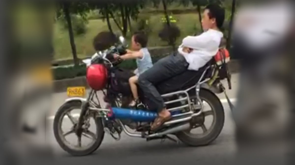 A four-year-old gives his father a ride in China. (Photo: AP/Newsflare screengrab)