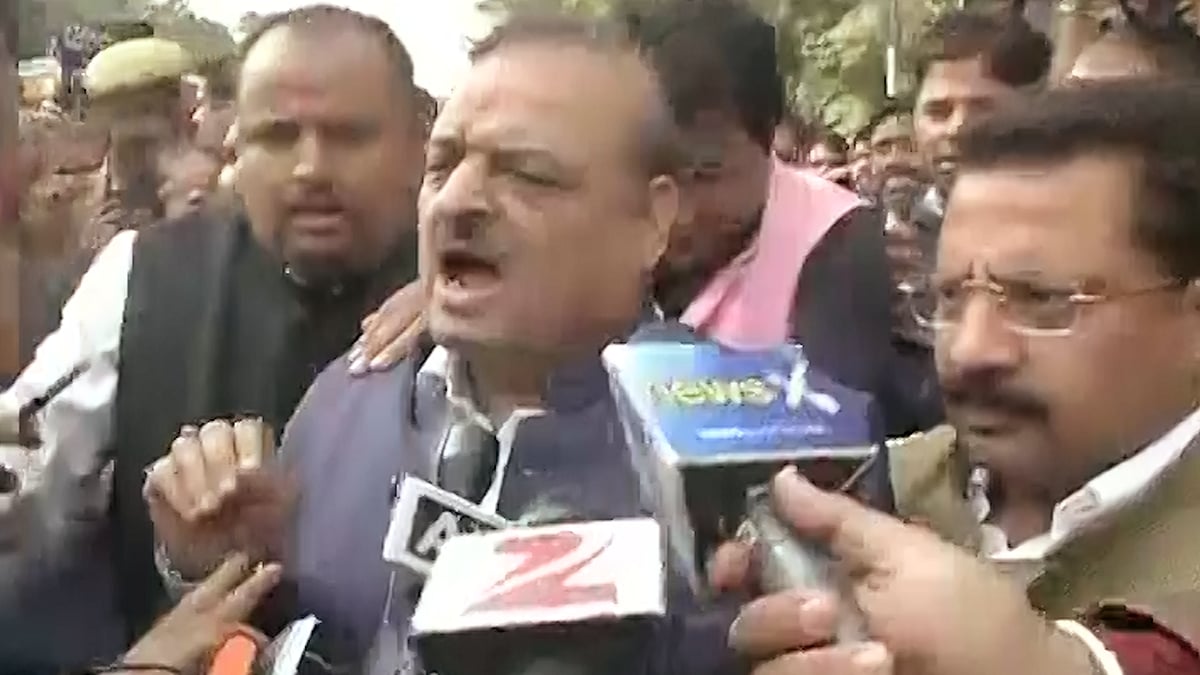 Delhi BJP MLA OP Sharma and his supporters beat up an unidentified man outside the Patiala House court. (Photo: ANI screengrab)