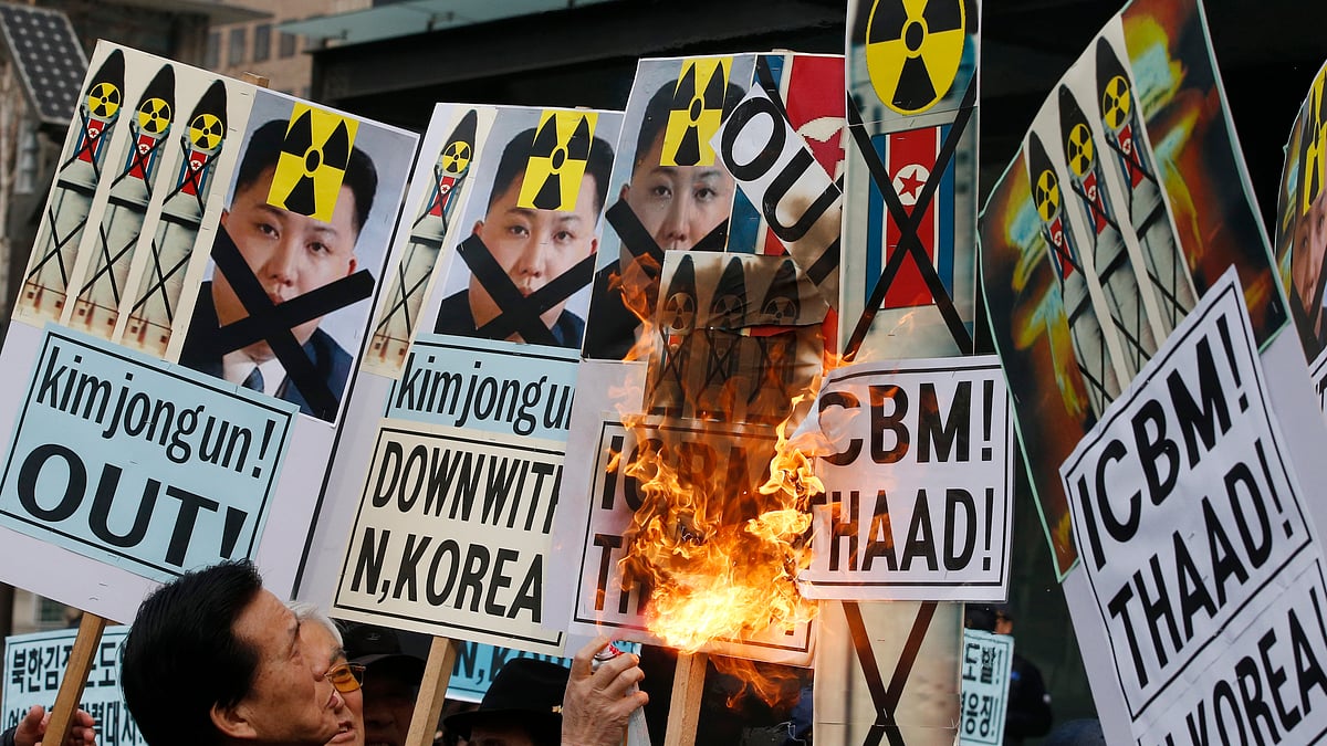 An anti-North Korea protester burns a pictures of the North’s leader Kim Jong Un and pictures of North’s missiles during a rally in downtown Seoul, South Korea, Thursday, 11 Feb 2016.