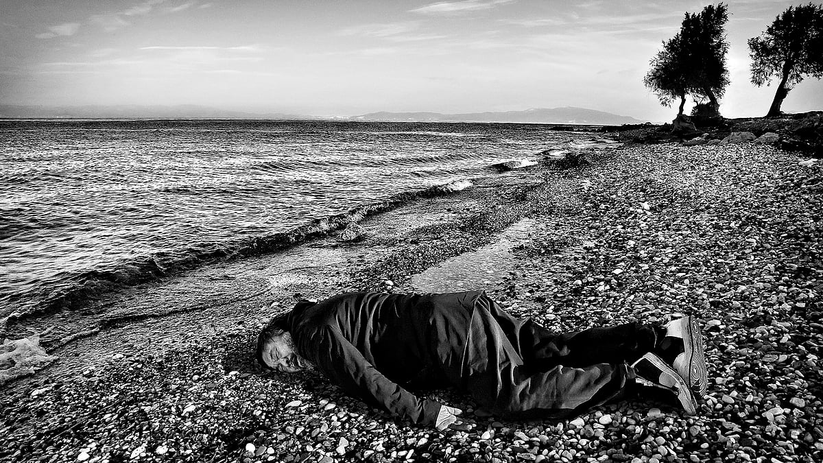 Chinese artist and activist Ai Weiwei posing as he lies face down on the beach on the Greek island of Lesbos. (Photo: AP)