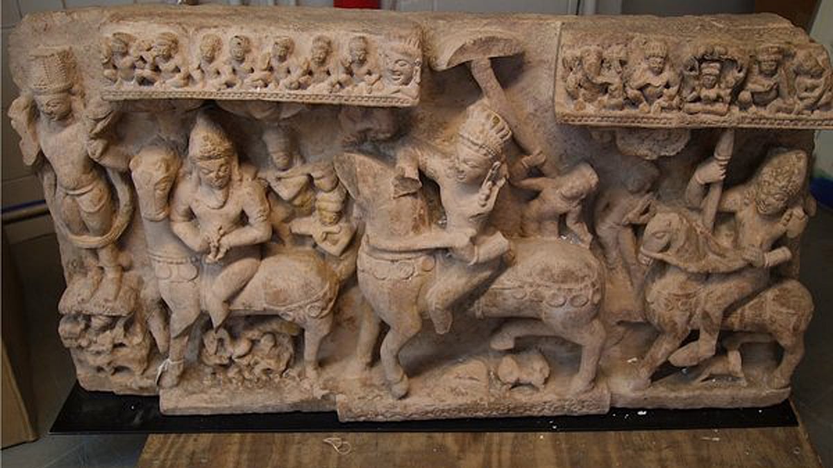 A stolen buff sandstone panel depicting Revanta and his entourage.  (Photo: US Customs/IANS)